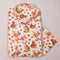 Folded shirt with squirrel and nut pattern on a light gray background