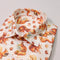 Shirt with a pattern of squirrels and nuts on a light background