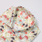 Floral-patterned fabric with mushrooms on a white background