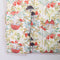 Floral-patterned shirt with mushrooms and apples on a white background