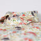 Floral patterned shirt with a button on a white background