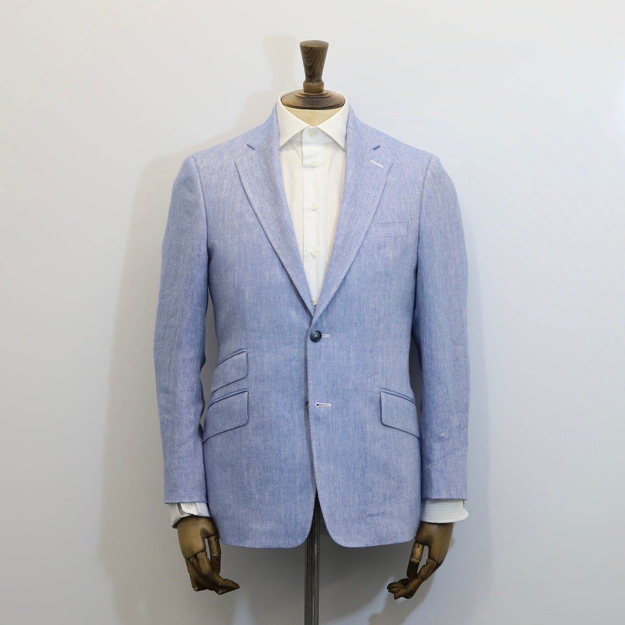 Light blue blazer on a mannequin against a white background