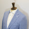 Blue blazer on a mannequin against a plain background