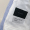 Blue linen fabric with a Spence Bryson Linens label on a light background